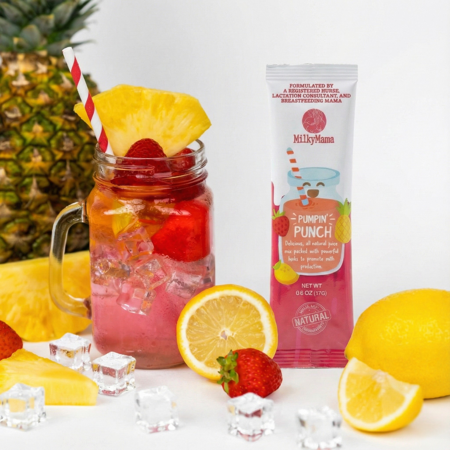 Pineapple juice with fruit and a MilkyMama pumpkin punch pouch on a white background