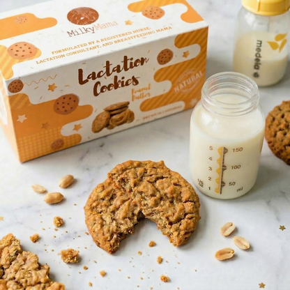 Lactation cookies with a box, bottle of milk, and cookie on a marble surface.